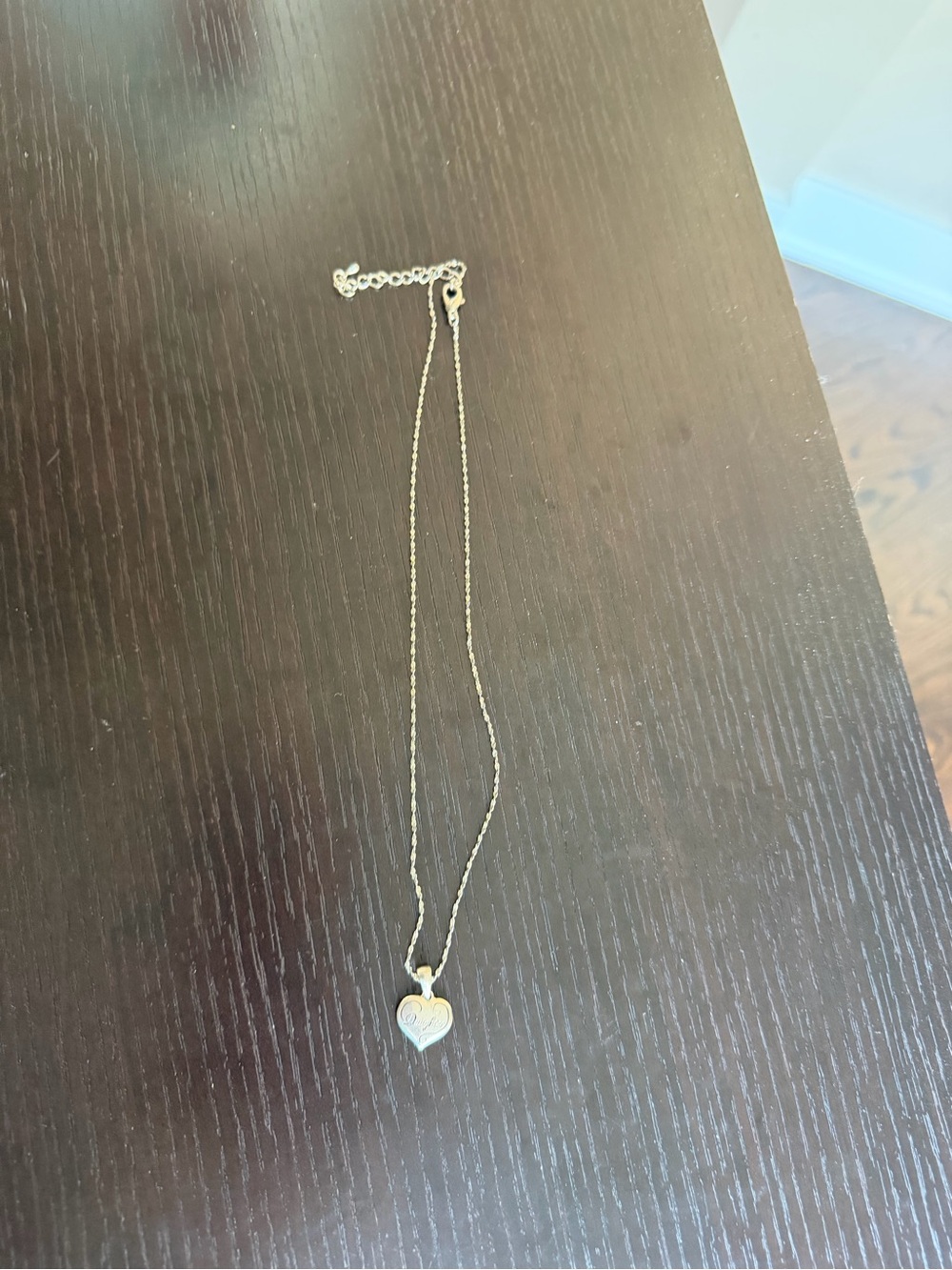 Silver-toned chain necklace featuring an engraved “daughter” heart pendant